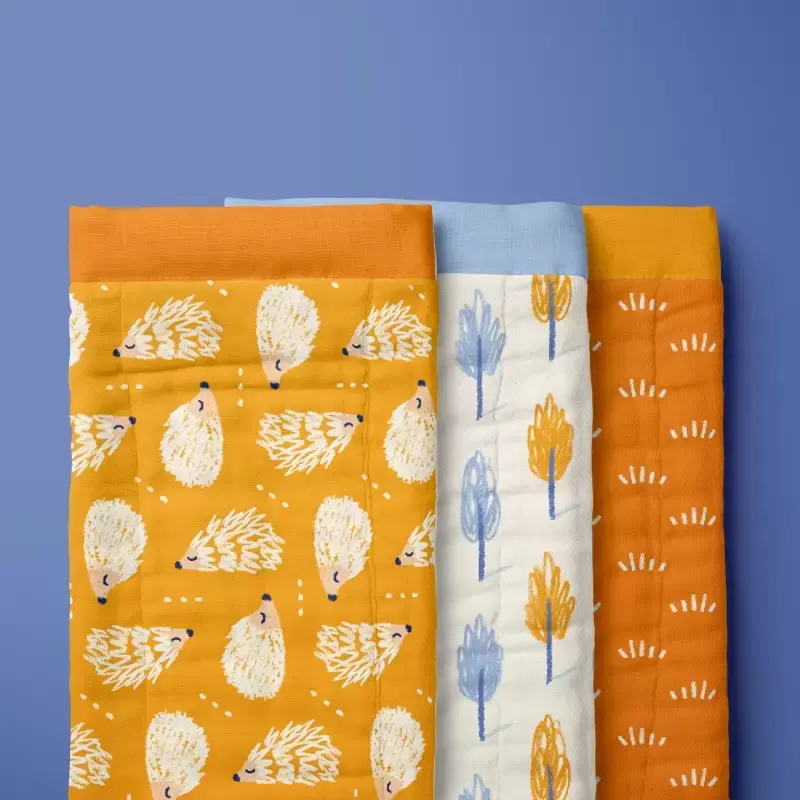 Burp cloth with hedgehog, trees and grass pattern