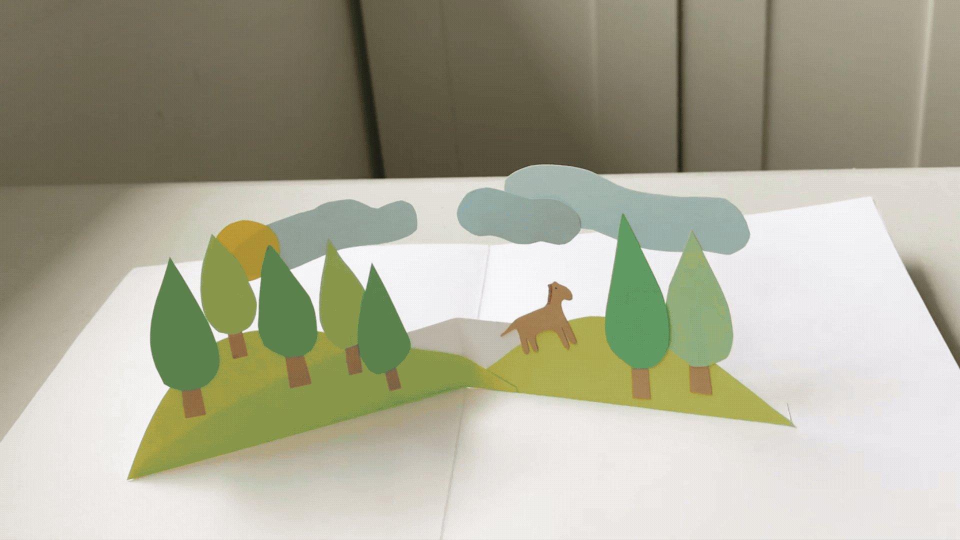 Examples of pop up cards with different scenes pated on a V fold insert.